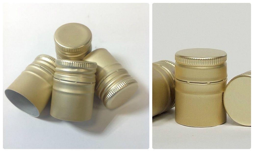 Gold aluminum ROPP closures showing precision thread forming and pilfer-proof band